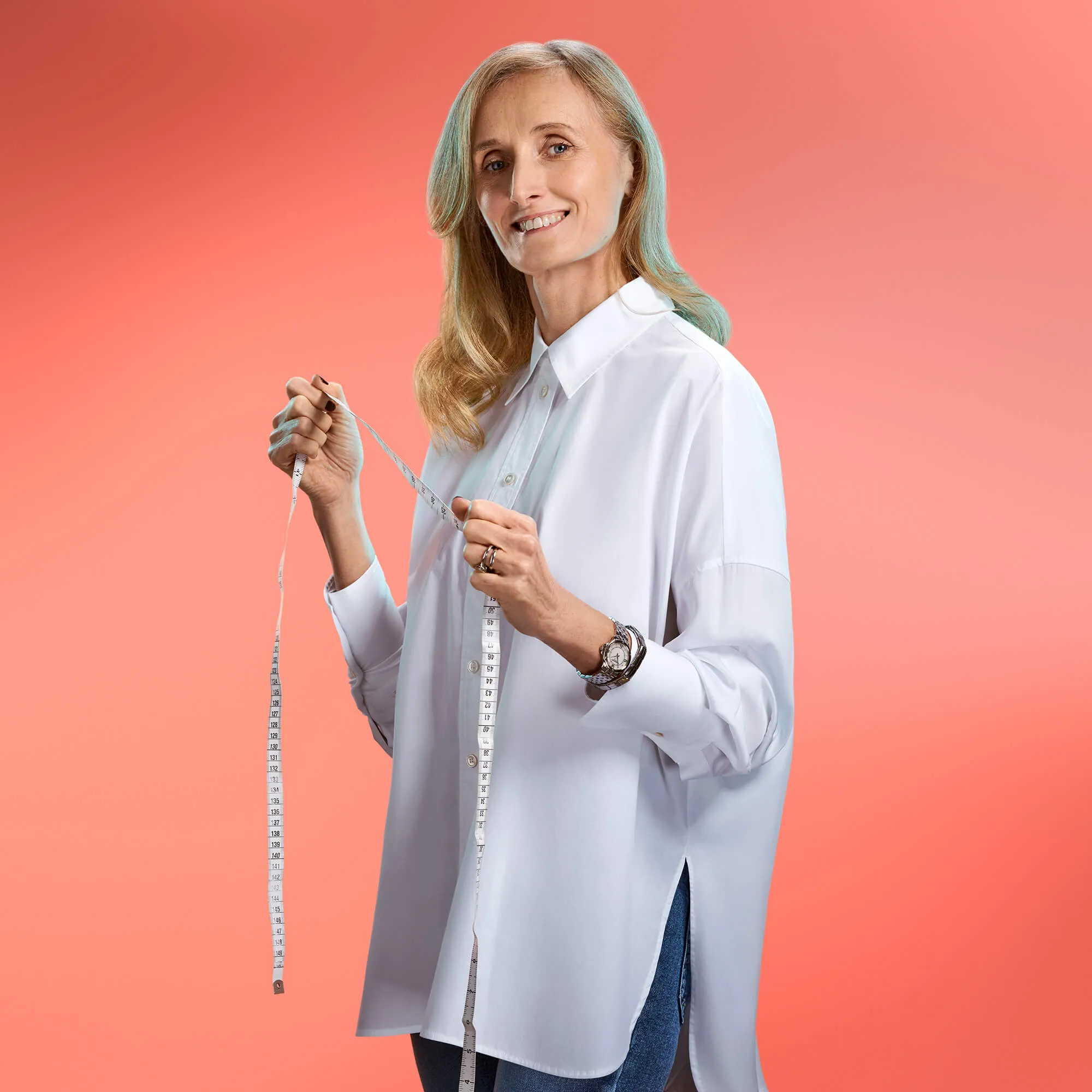 An image of a woman in a white shirt holding a measuring tape against a pink background | FBD Insurance