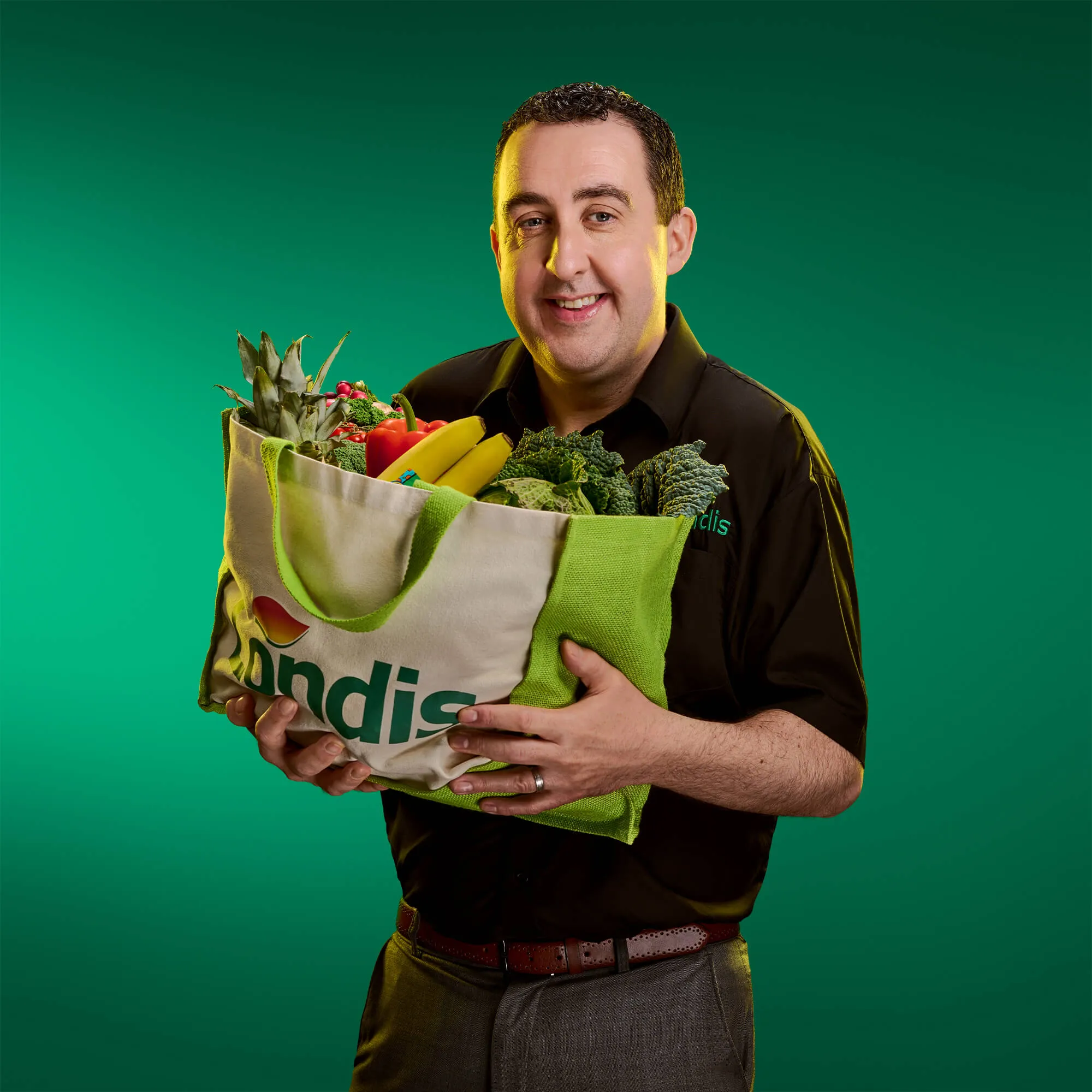 An image of a man with a bag of groceries on a green background | FBD Insurance