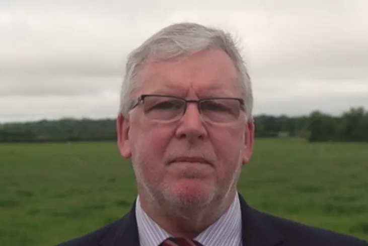 A close-up picture of a mans face with a green field in the background | FBD Insurance